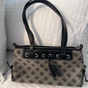 Dooney & Bourke zipper bag with tassels. Never been used.